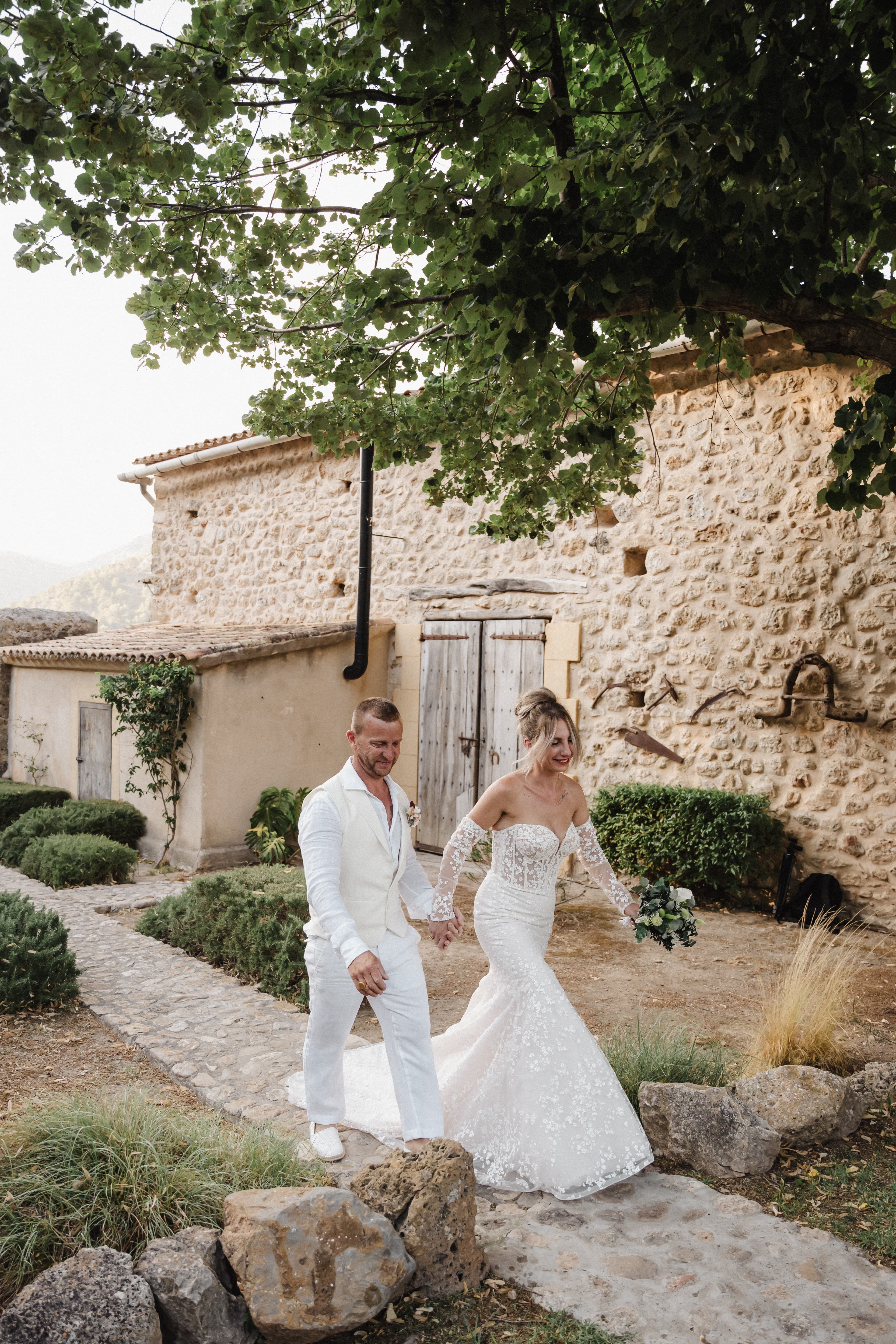 mariés cristina et bruno marchant dans les jardins du domaine à palma de majorque